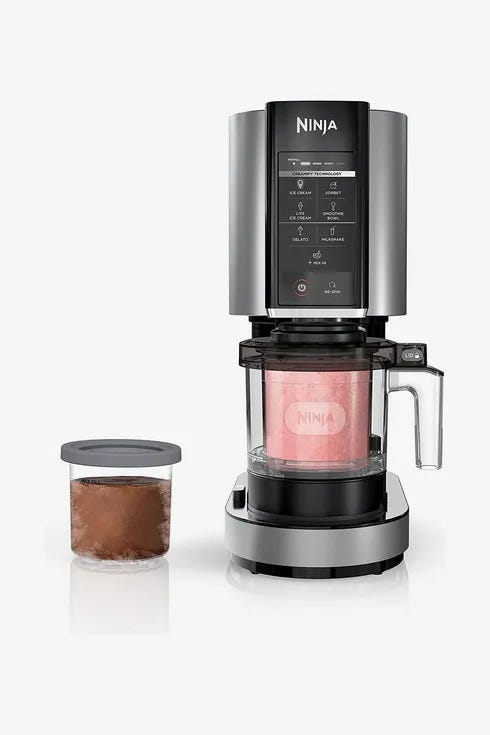 Ninja Creami ice cream maker with a pint of chocolate ice cream next to the machine